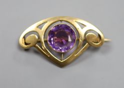 An early 20th century Art Nouveau yellow metal and amethyst set stylised brooch,36mm, gross weight