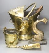 A brass coal bucket, a dolphin door porter, a scoop and a small pail, tallest 47cm