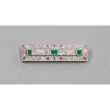 An Art Deco pierced 18ct and plat, emerald and diamond millegrain set rectangular brooch,40mm,