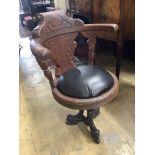 A continental carved oak and cast iron music chair