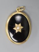 A Victorian Dublin oval yellow metal black enamel and split pearl set locket (Irish by family