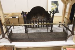 A wrought iron fire grate, a pair of fire dogs and a Regency brass tipped wire mesh fire guard,