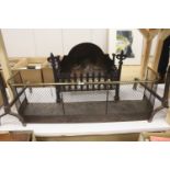 A wrought iron fire grate, a pair of fire dogs and a Regency brass tipped wire mesh fire guard,