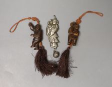 A Chinese metal baby's rattle and two carved wood figural pendants