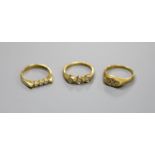 Three assorted modern 18ct gold and diamond set rings, including two three stones and a seven stone