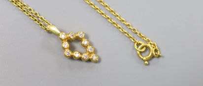 A modern 18ct gold and ten stone diamond chip set pendant, 16mm, on an 18ct chain, 37cm,gross 4.3
