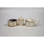 A modern George III style pierced and engraved shaped overal three peice condiment set.