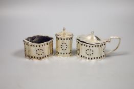 A modern George III style pierced and engraved shaped overal three peice condiment set.