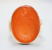 A modern Victorian style 9ct gold and oval carnelian set signet ring (adapted),the matrix carved