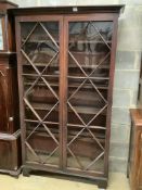 A George III mahogany bookcase with two astragal glazed doors, on later feet, width 116cm