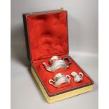 A cased late 19th/early 20th century French demi fluted white metal three piece tea set, by Edmond