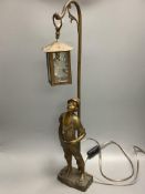 An early 20th century bronzed spelter whistling boy table lamp, 65cm.