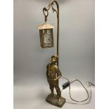 An early 20th century bronzed spelter whistling boy table lamp, 65cm.