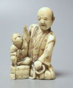 A Japanese ivory group of a man with a monkey, 19th century, 6.5cm high