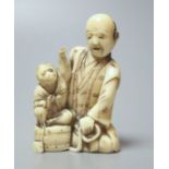 A Japanese ivory group of a man with a monkey, 19th century, 6.5cm high