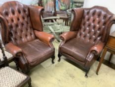 A pair of buttoned burgundy leather wing armchairs, width 86cm, depth 80cm, height 110cm