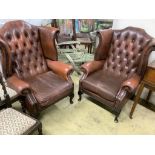 A pair of buttoned burgundy leather wing armchairs, width 86cm, depth 80cm, height 110cm