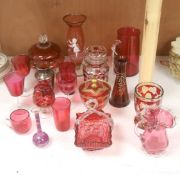 A collection of cranberry and ruby glassware including a 'Mary Gregory' vase