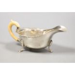 A George VI silver ivory handled sauceboat, Viners Ltd, Sheffield, 1937,length 15.2cm, gross 111