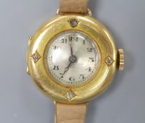 A lady's early to mid 20th century 18k yellow metal and diamond set manual wind wrist watch, on a