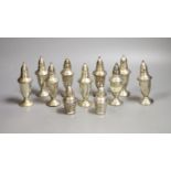 A set of nine weighted sterling pepperettes, 12.5cm and two smaller similar pepperettes.