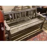 A weathered teak wooden garden bench, length 154cm, depth 56cm, height 91cm