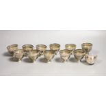 A set of twelve pierced small white metal footed cups,height 5cm, 13oz.