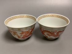 A pair of Chinese iron red 'dragon' cups, height 6cm