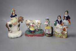 A North Country pearlware milkmaid group, c.1820, two Staffordshire figure groups and a Continental