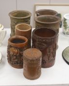 Six 19th/20th century Chinese carved brush pots and a similar carved tea caddy, tallest 20cm