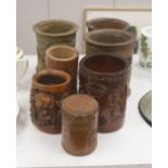 Six 19th/20th century Chinese carved brush pots and a similar carved tea caddy, tallest 20cm