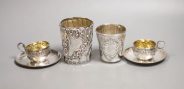 A pair of French white metal cups and saucers and two similar tumblers,8oz.