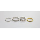 Two platinum wedding bands, 7.8 grams, an 18ct white gold wedding band, 3.7 grams and a 22ct gold