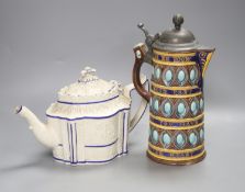 A Wedgwood majolica motto jug, 27cm high and a Regency white stoneware teapot and cover