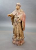 A large carved hardwood study of a standing monk or Saint, early 20th centuryWith polychrome