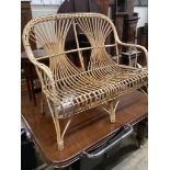 A 1970's bamboo and cane two seater conservatory settee, length 110cm, depth 52cm, height 97cm