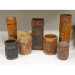 Three Chinese carved bamboo tea caddies and four carved bamboo brush pots
