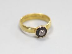 A modern 19th century style 18ct gold, black onyx and diamond set target ring,size O, gross weight