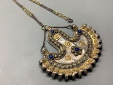 An Afghan? parcel gilt white metal and cabochon lapis lazuli demi-lune shaped pendant necklace,