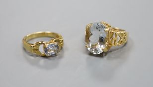 A pale aquamarine ring, pierced 18ct gold setting and shank and an 18ct gold and pale sapphire