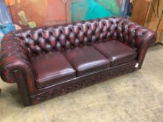 A Victorian style buttoned burgundy leather three seater Chesterfield settee, width 200cm depth