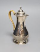 A George V silver hot water pot with rattan handle, London, 1919,height 20.8cm, gross 11oz.