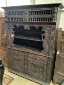 A late 19th century Flemish carved oak cabinet, width 145cm depth 48cm height 190cm