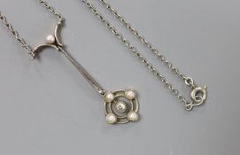 An Edwardian yellow and white metal, seed pearl and diamond set cluster drop pendant necklace,