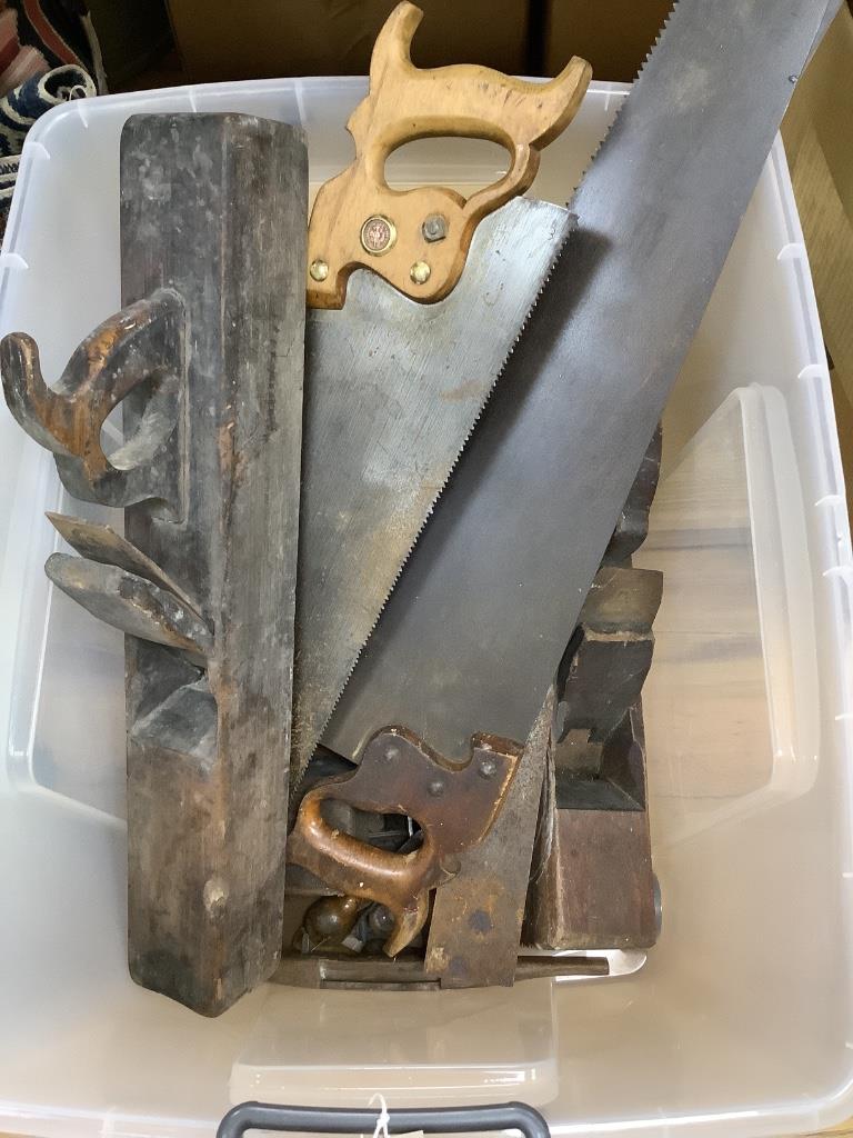 A collection of vintage tools including woodworker's planes and saws