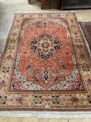 An Indian Heriz style red ground carpet, 270 x 108cm