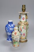 A Chinese famille rose converted lamp, a similar blue and white vase and another vase and cover,