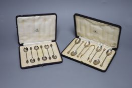 A cased set of six seal top teaspoons and tongs and a cased set of silver silver bean end coffee