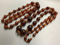 Two single strand reconstituted and natural amber necklaces, both approximately 80 cm, gross weight