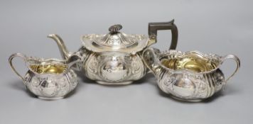 An Edwardian embossed silver three piece tea set, Hammond, Creake & Co, Sheffield, 1903,gross 41.